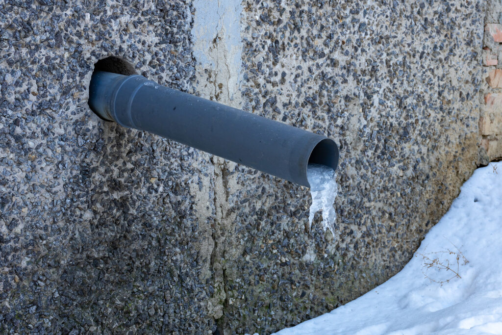 A water pipe in a house with a frozen piece of ice rainwater ha