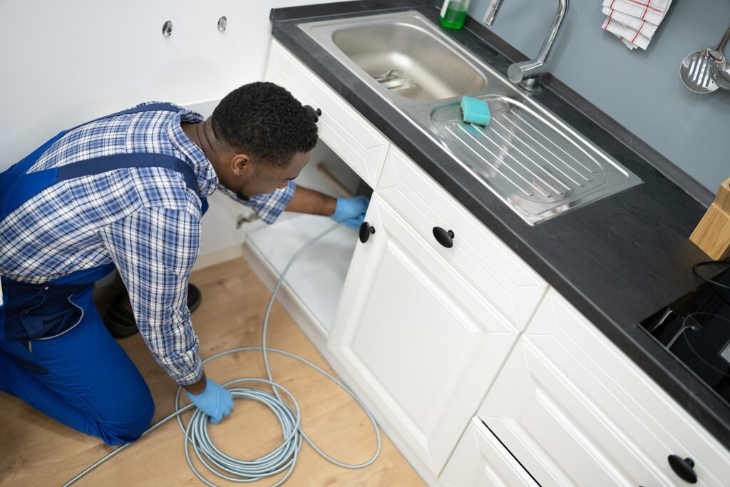 Plumber drain cleaning services in kitchen unclog blocked pipe