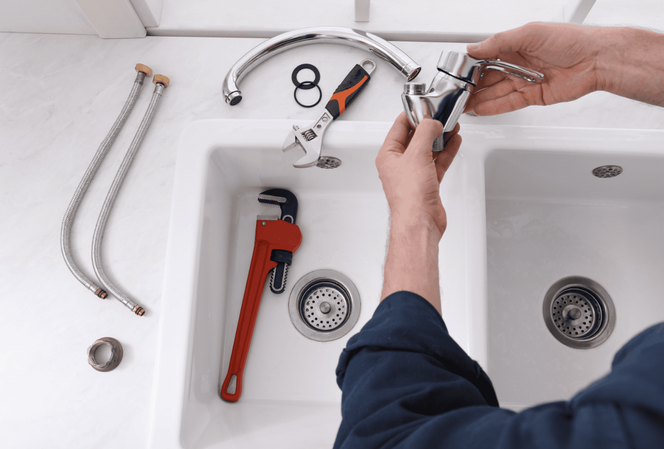 Plumber fixing a hand basing in kitchen